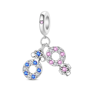 Macro shot of silver gender symbol charms with blue and pink pavé zircon stones