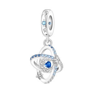 Detail of silver charm with blue heart stone and sparkling starry planetary motifs