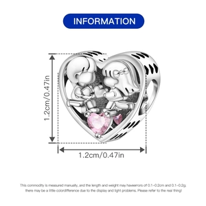 Detailed size view of silver heart bead with boy and girl relief and pink zircon