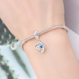 Macro shot of S925 sterling silver star charm with blue zircon on a snake bone bracelet