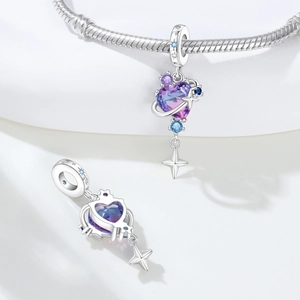Macro detail of heart charm with purple-blue gradient stone and star dangle on snake chain