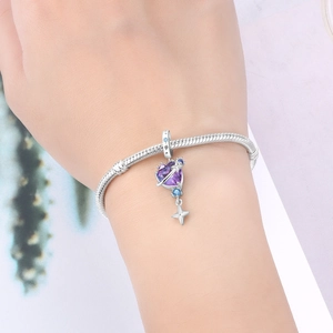 Silver celestial charm bracelet with purple planet pendant and blue zircon star