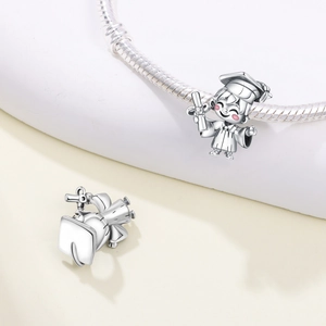 Detailed view of silver graduation girl charm with academic cap on snake chain