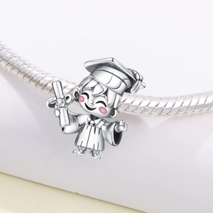 Macro view of silver graduation boy charm with white zircon on snake chain