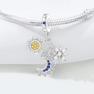 Macro detail of sun moon and star charms with blue and yellow cubic zirconia stones