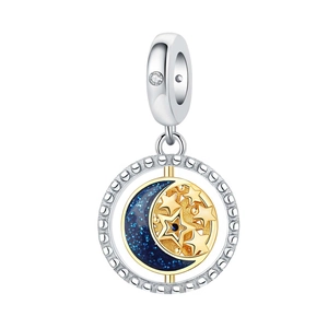Detail of silver star and moon charm with blue enamel and sparkling zircon stones