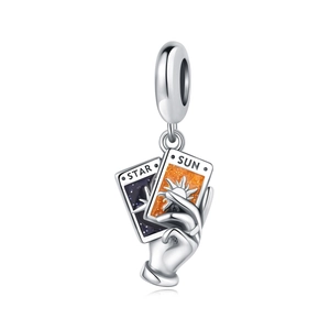 Detailed view of silver charm pendant featuring hand holding Star and Sun tarot cards