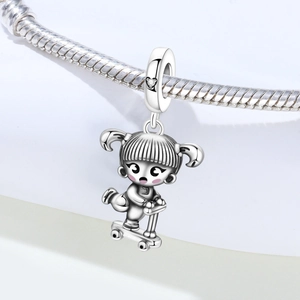Macro view of silver girl skateboarder charm with heart zircon on snake chain bracelet