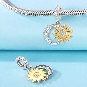 Macro view of sun and moon charm with sparkling white zircons on a snake chain