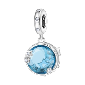 Macro shot of silver eight-pointed star charm with a light blue crystal center