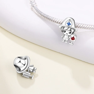 Detail of a firefighter charm bead with blue cross helmet on a silver snake chain