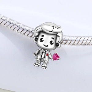 Macro shot of silver cartoon doctor charm with pink heart zircon on snake chain