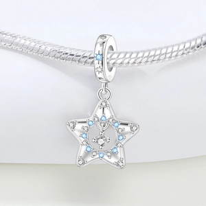 Macro shot of silver star charm with blue and white zircons on a snake chain