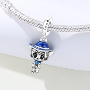 Detail of silver cartoon boy charm with blue enamel hat on a snake chain bracelet