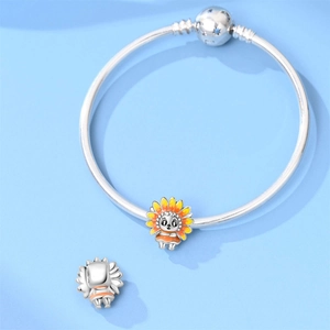 Detail of silver snake chain bracelet with cartoon sunflower charm charms on blue background