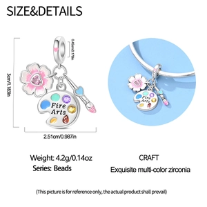 Macro shot of silver charm with palette and brush charms featuring colorful zirconia