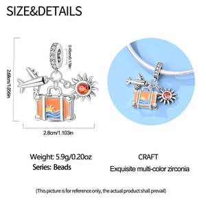 Detail of travel charms with airplane, suitcase, and sun showing 2.68cm dimensions