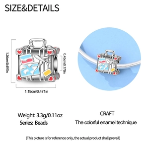 Detail view of suitcase bead charm with colorful enamel stickers and exact dimensions