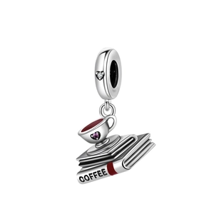 Detailed view of silver charm featuring stacked books, coffee cup and pink heart zircon