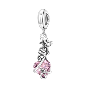 Detailed view of silver butterfly and rose charm with heart-shaped pink gemstone