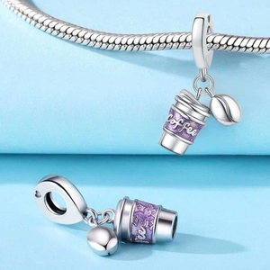 Detail of silver coffee cup charm with purple enamel and a small coffee bean pendant