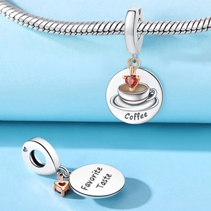 Macro view of silver coffee cup charm with red heart zircon and Favorite Taste engraving