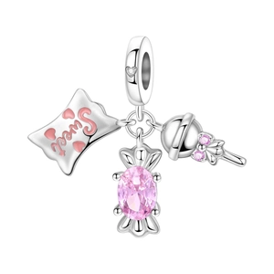 Close-up of silver charms featuring pink Sweet pillow and sparkling candy gemstone