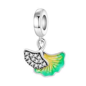 Detailed macro of a ginkgo leaf charm with green enamel and micro-set cubic zirconia