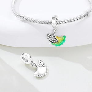 Macro shot of ginkgo leaf charm with yellow-green enamel and sparkling cubic zirconia