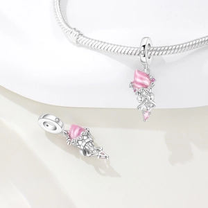 Macro detail of silver ice cream charm with pink enamel and zircons on snake chain