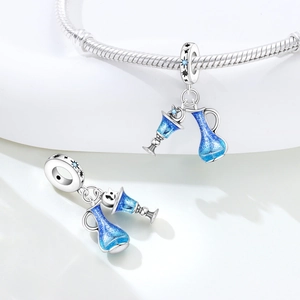 Close-up of silver charms with gradient blue enamel and stars for charm bracelets
