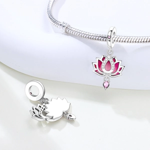 Macro detail of silver lotus flower charm with pink enamel and sparkling zircon stones