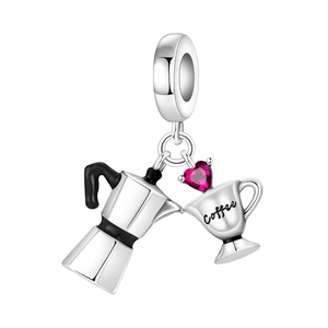 Macro detail of silver mocha pot and coffee cup charm with heart-shaped pink gemstone