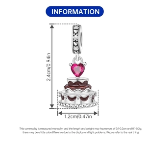 Detailed view of silver cake pendant with red heart gem and size measurements