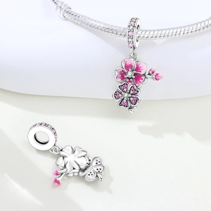 Detailed view of pink enamel cherry blossom charm with sparkling zircons in silver