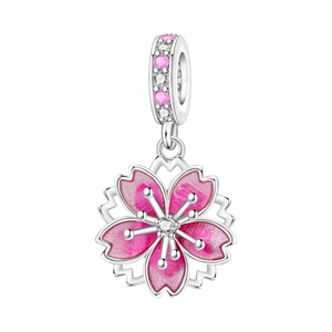 Macro shot of silver cherry blossom charm with pink enamel and sparkling crystals