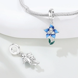 Close-up of blue enamel iris flower charm with zircon and silver leaf pendant detail