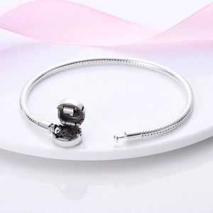 Macro detail of S925 sterling silver snake chain bracelet with barrel clasp and engraving