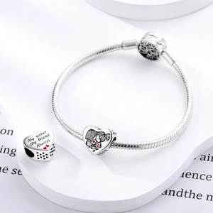 Detailed view of silver heart charms with Forever and My sister My friend engraving