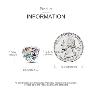Detailed size comparison of a heart charm with colorful zircons and a dollar coin