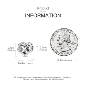 Detail view of silver heart charm with green clover and dimensions compared to a coin