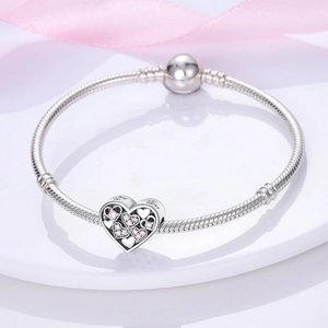 Silver snake chain bracelet featuring heart pendant with pink gems and love engraving