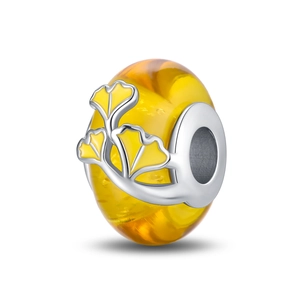 Detailed charm view featuring luminous yellow glass beads and silver ginkgo leaf patterns