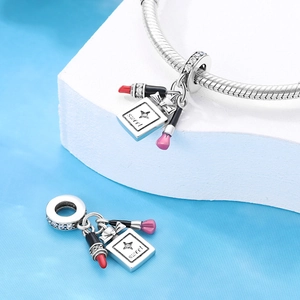 Silver lipstick and perfume charms on snake chain bracelet with pink enamel accents