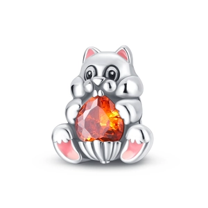 Detailed view of squirrel charm with pink enamel ears and a heart orange zircon stone