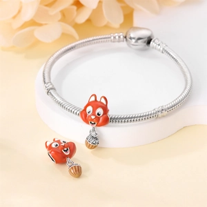 Detail of silver squirrel charm with enamel acorn and crystals on snake chain bracelet