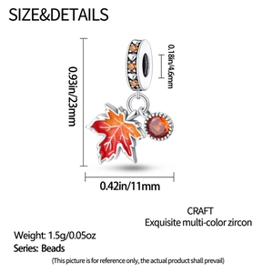 Detailed close-up of a maple leaf charm with orange zircon and enamel coating