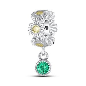 Macro detail of sunflower charm with yellow crystals and green gemstone pendant