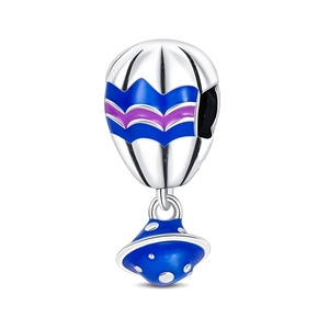 Macro shot of silver hot air balloon and UFO charm with blue enamel for charm bracelets