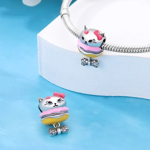 Silver cat burger charm with enamel details and sparkling bow on a snake chain bracelet